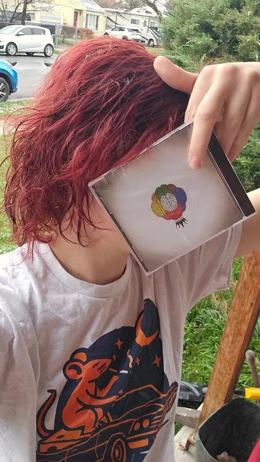 Fan holding the CD up outside