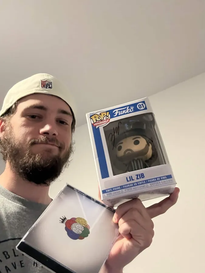 Fan holding the CD and a signed figure